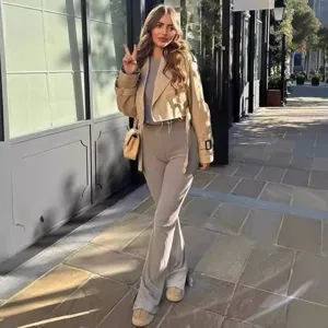 Women's short casual solid color raw-edge trench coat paired with stylish outfit for daily wear.