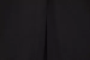 Close-up detail of black dress fabric showing neat stitching and fine texture craftsmanship.