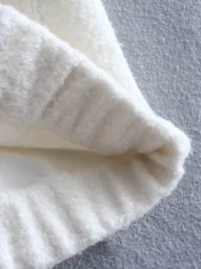 White fuzzy fleece casual jacket detail close-up, soft stand collar winter warm outerwear.