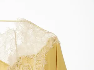 Exquisite French style lace trim detail on lightweight chiffon fabric, elegant V-neck design.