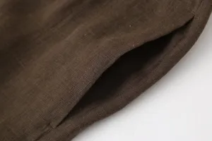 Brown linen clothing pocket detail close up, natural fabric texture and breathable style