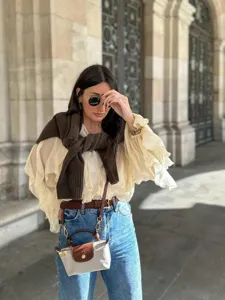 Detailed view of women's chic ruffle long sleeve blouse, elegant V-neck design for style.
