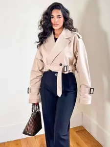 Chic cropped beige trench coat detail, stylish raw hem and classic double-breasted design.