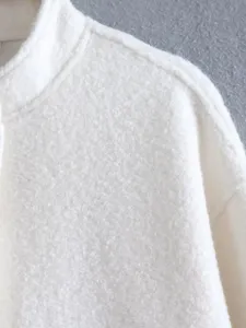 Detail close-up shot of a white fleece stand collar jacket showcasing soft textured fabric.
