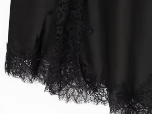 Black satin slip dress detail featuring exquisite lace trim, highlighting delicate fabric texture.