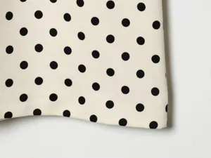 Detailansicht der eleganten französischen Vintage-Stofftextur mit schwarzen Punkten.