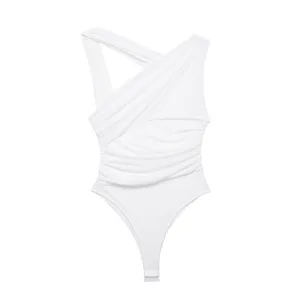 Detail shot of the white asymmetric ruched bodysuit featuring stylish cross straps and soft mesh.