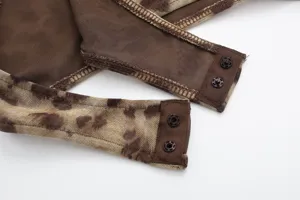 Close-up detail of women brown leopard mesh bodysuit featuring snap button closure and stitching.