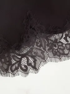 Black lace trim detail close up, elegant fashion dress accessory, delicate texture fabric design.