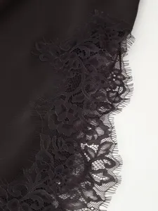 Black lace trim fabric detail of stylish cutout fashion autumn winter women long dress close up