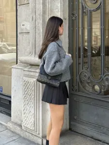 Autumn tweed short jacket detail, stylish retro design, elegant street style outfit showcase.
