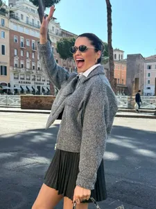 Women's casual short tweed jacket and pleated skirt set, fashionable autumn outerwear style.