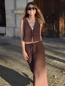 Outdoor lifestyle detail view of the brown textured sleeveless crop top and skirt set.