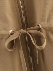 Close-up detail of khaki jacket zipper drawstring and metal eyelets texture design view