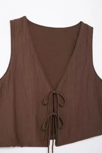 Brown textured sleeveless top detail, v-neck with front tie closure, summer fashion apparel.
