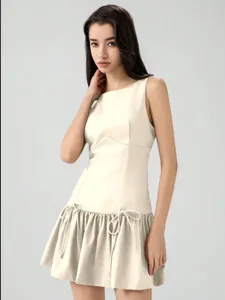 Sleeveless mini dress with bow decoration, resort style, elegant beige design for summer.