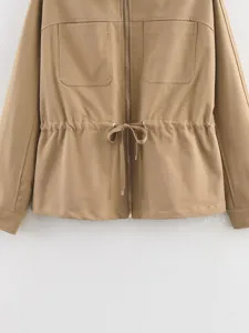 Close-up of khaki utility jacket with front zipper, chest pockets and drawstring waist.
