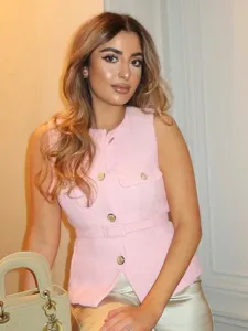 Chic pink tweed sleeveless vest for women, featuring gold tone buttons and a stylish matching belt.