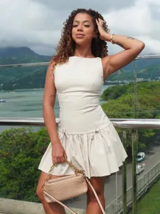 Sleeveless mini dress with waist bow string details, perfect for resort and summer wear.