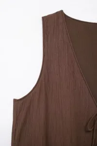 Dark brown textured sleeveless top detail view, V-neck crinkle fabric vest close-up display.