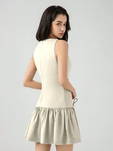 Sleeveless mini dress in beige with pleated hem, elegant solid design for summer vacation.