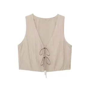 Detail shot of women's beige textured front tie vest top, V-neck design with elegant ribbon bows.