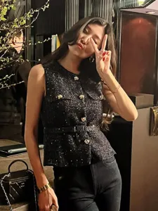 Stylish black tweed sleeveless vest with gold metal buttons and chic belt for women.