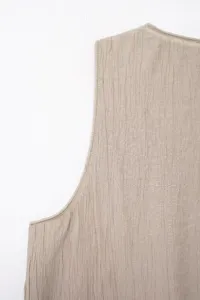 Detail shot of textured sleeveless vest top shoulder and armhole seam craftsmanship.