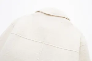 Close up detail view showing the back collar and textured fabric of the short jacket.