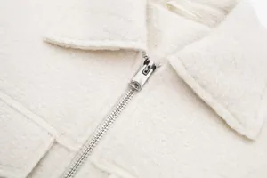 Close-up detail of women short tweed jacket collar and metal zipper, fine texture design.