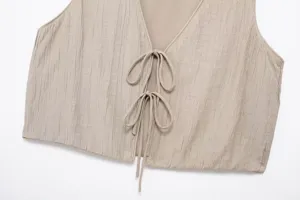 Detailed view of khaki textured V-neck vest top with stylish double front tie closure.