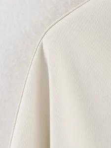 Close-up view of elegant beige women clothing fabric texture with refined edge piping detail