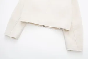Close up detail of women short tweed jacket zipper cuff and hem texture white background