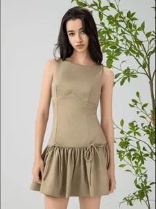 Sleeveless khaki resort dress featuring elegant bow ties and flared skirt details.