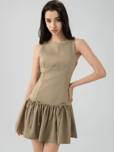 Close-up details of the sleeveless mini dress showcasing unique waist drawstring bow accents.
