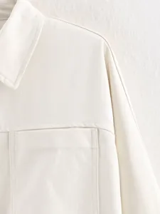 Casual off-white long sleeve top detail view, premium twill fabric with chic pocket.