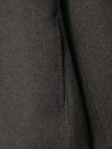 Dark grey woolen fabric texture detail close-up showcasing fine winter coat material quality.