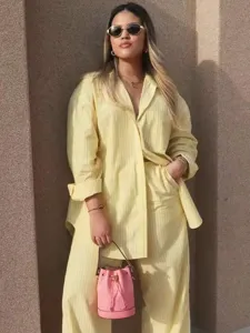 Detail view of women's casual striped long sleeve shirt and trousers set for summer.