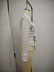 Side view of women long sleeve polka dot shirt detail, elegant casual blouse with belt.