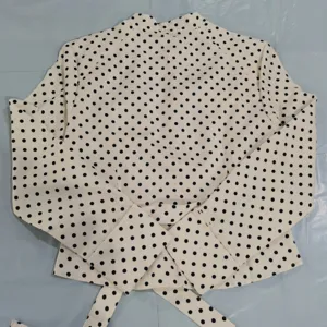 Women chic polka dot long sleeve blouse flat lay detail fashion elegant office wear top