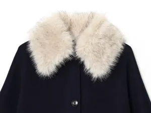 Close-up detail of women's dark blue wool coat featuring a soft white faux fur collar.