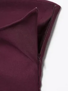 Close-up detail of women's burgundy top fabric texture and fine hidden zipper design.