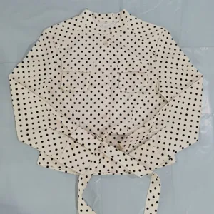Women polka dot long sleeve blouse detail, cream black pattern, elegant daily wear top.