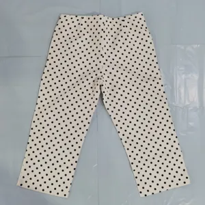 Women high waist polka dot trousers detail, classic black and white pattern fabric close up