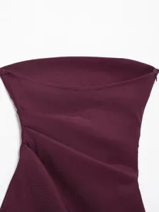 Close-up detail of the burgundy strapless top featuring stylish asymmetric draping and pleats.