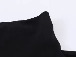 Black ribbed turtleneck fabric detail, fine texture, high elasticity for slim fit tops.