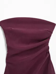 Dark burgundy strapless top detail, chic asymmetrical pleated design for modern elegant style.