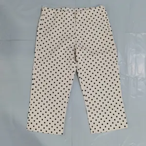 Women's high-waist polka dot casual trousers, classic black and white pattern for stylish daily wear.