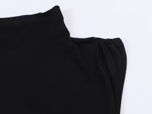 Close-up detail view of black mock neck sleeveless top showing shoulder pleats texture.