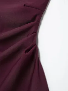 Detailed close-up view of the elegant burgundy ruched asymmetric top showcasing fine texture.
